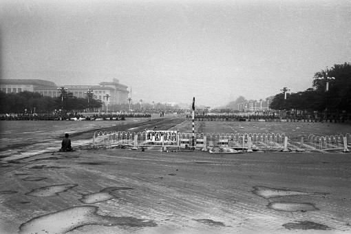 Beijing, China, June 4, 1989: On Changan Avenue, a solitary man faces the forces of the People's Liberation Army (PLA) in Tiananmen Square after the army stormed the square and the surrounding area the night before. This is near the location a day later where "Tank Man" confronted and momentarily halted a column of the army's tanks leaving the square. Photograph by ALAN CHIN