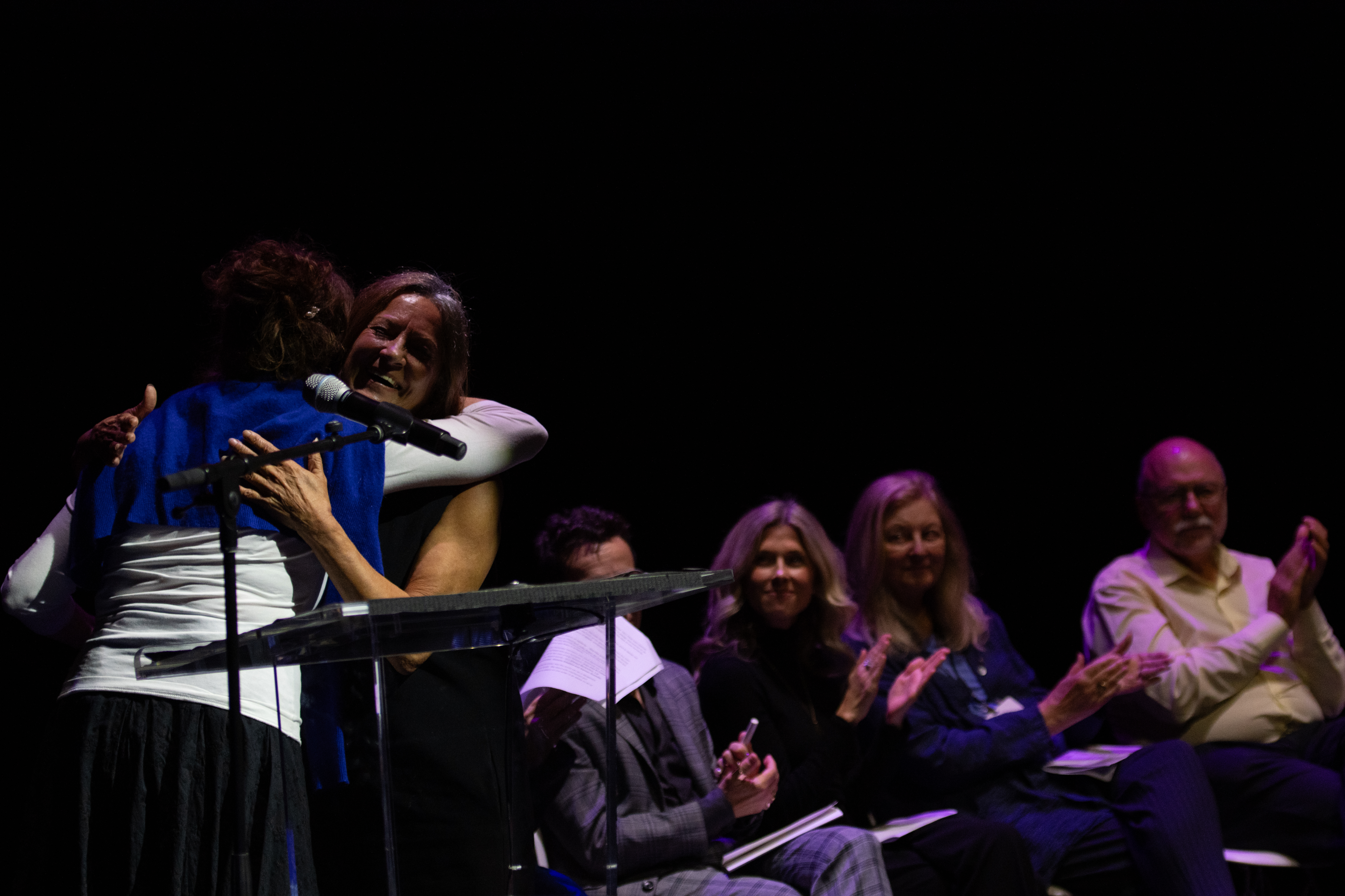 Joan Leishman accepting the Marie-Ange Garrigue Prize from Carol Off in 2023